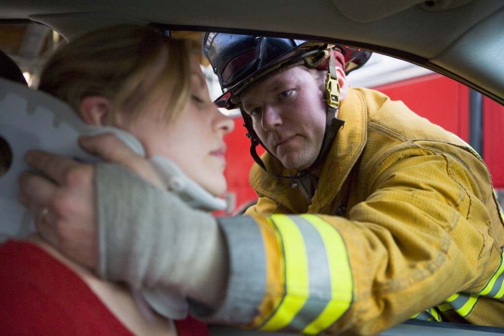 Fireman helping a woman