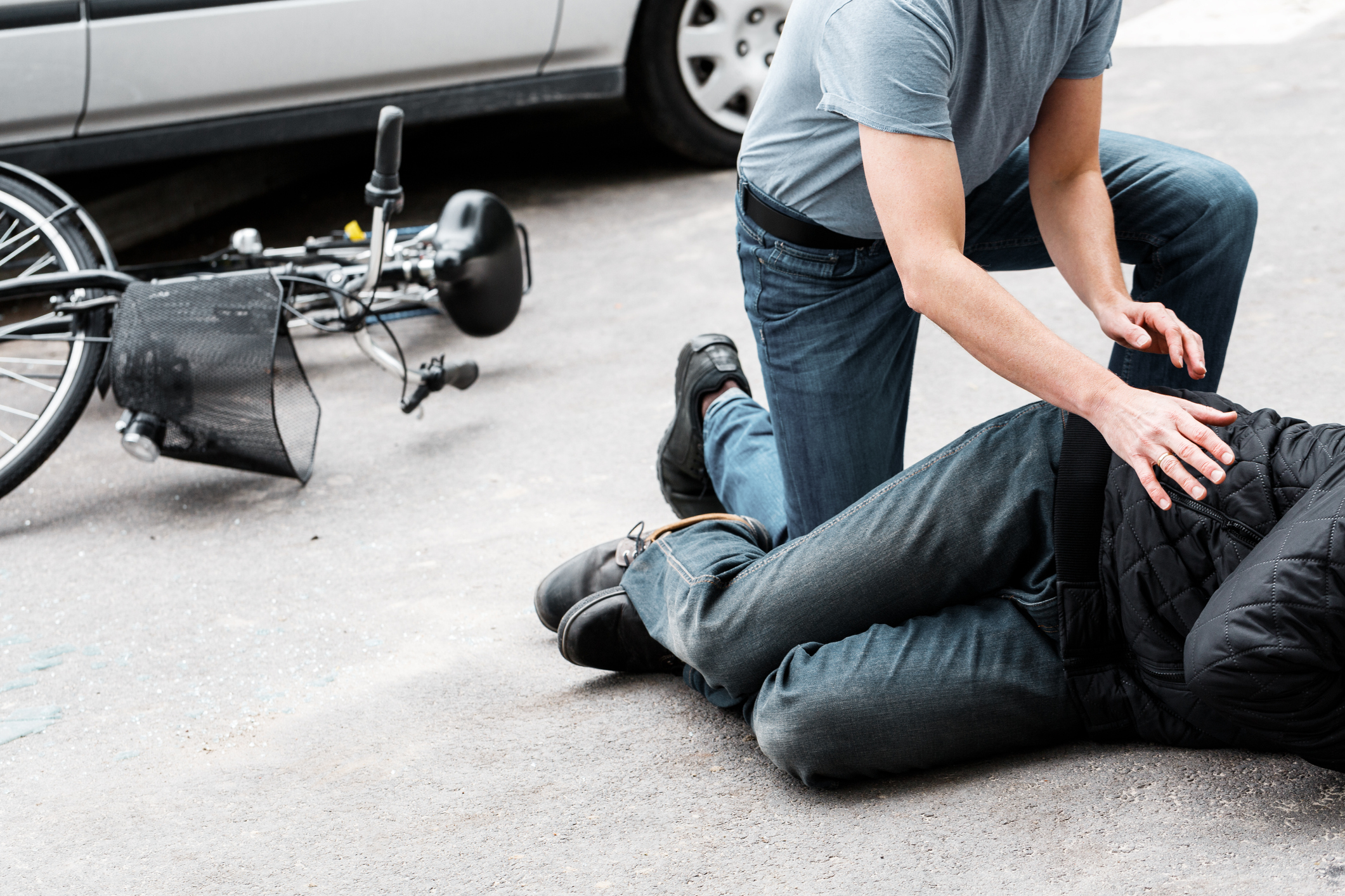 A pedestrian helps an injured man after a bicycle accident, then calls an Atlanta bicycle accident lawyer.