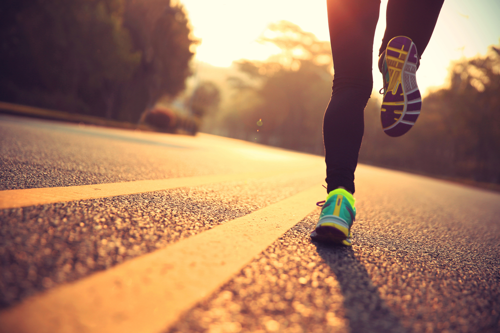 young fitness woman runner athlete running on road